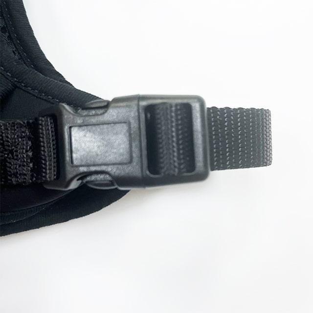 Close-up of the durable black plastic quick-release buckle on heavy duty dog harness
